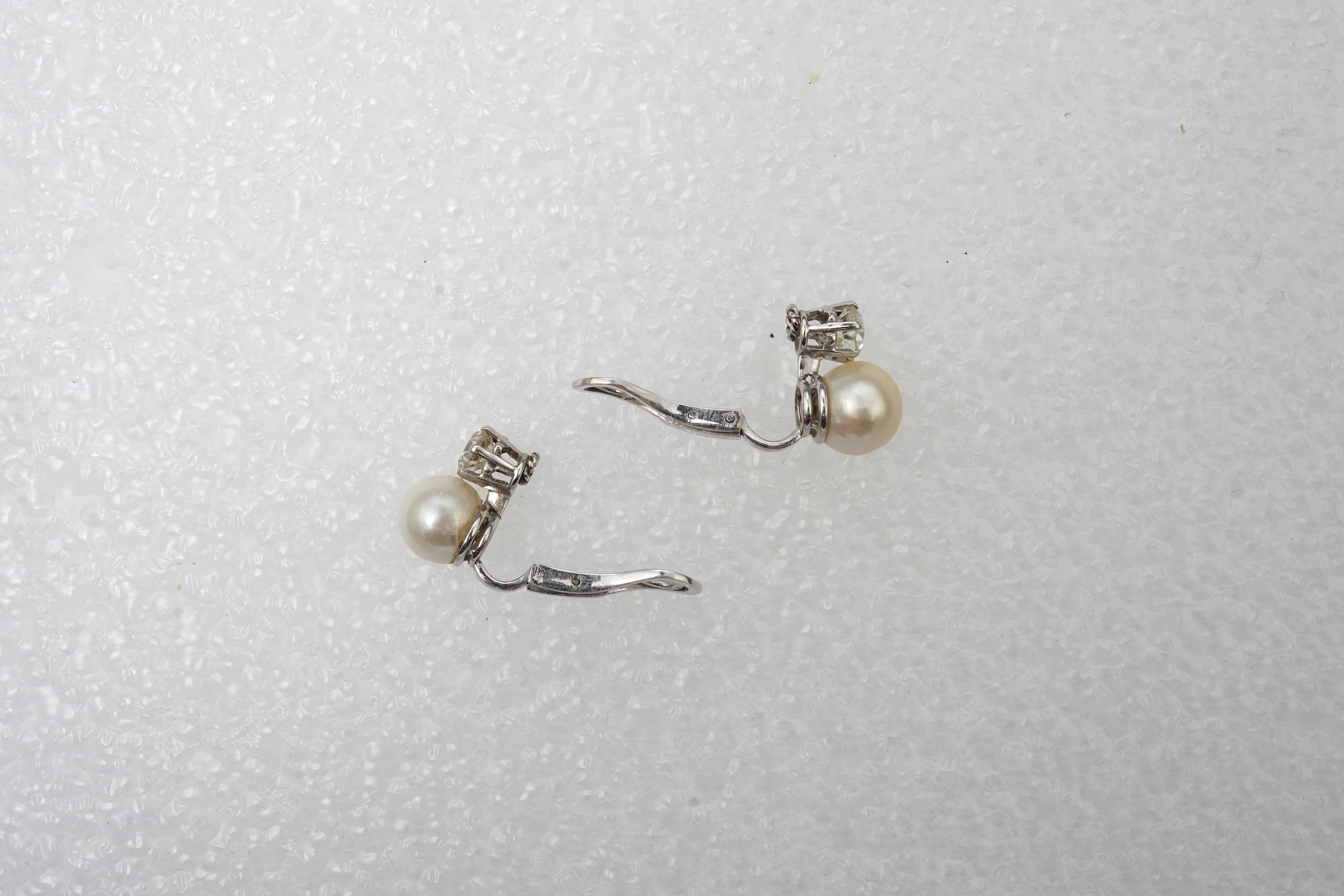 A pair of pearl and diamond ear clips, mid 20th century